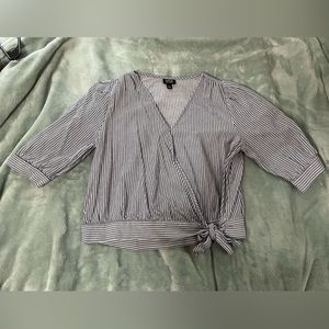 Striped white and blue blouse. Quarter lengths sleeves. Wrap in front with tie